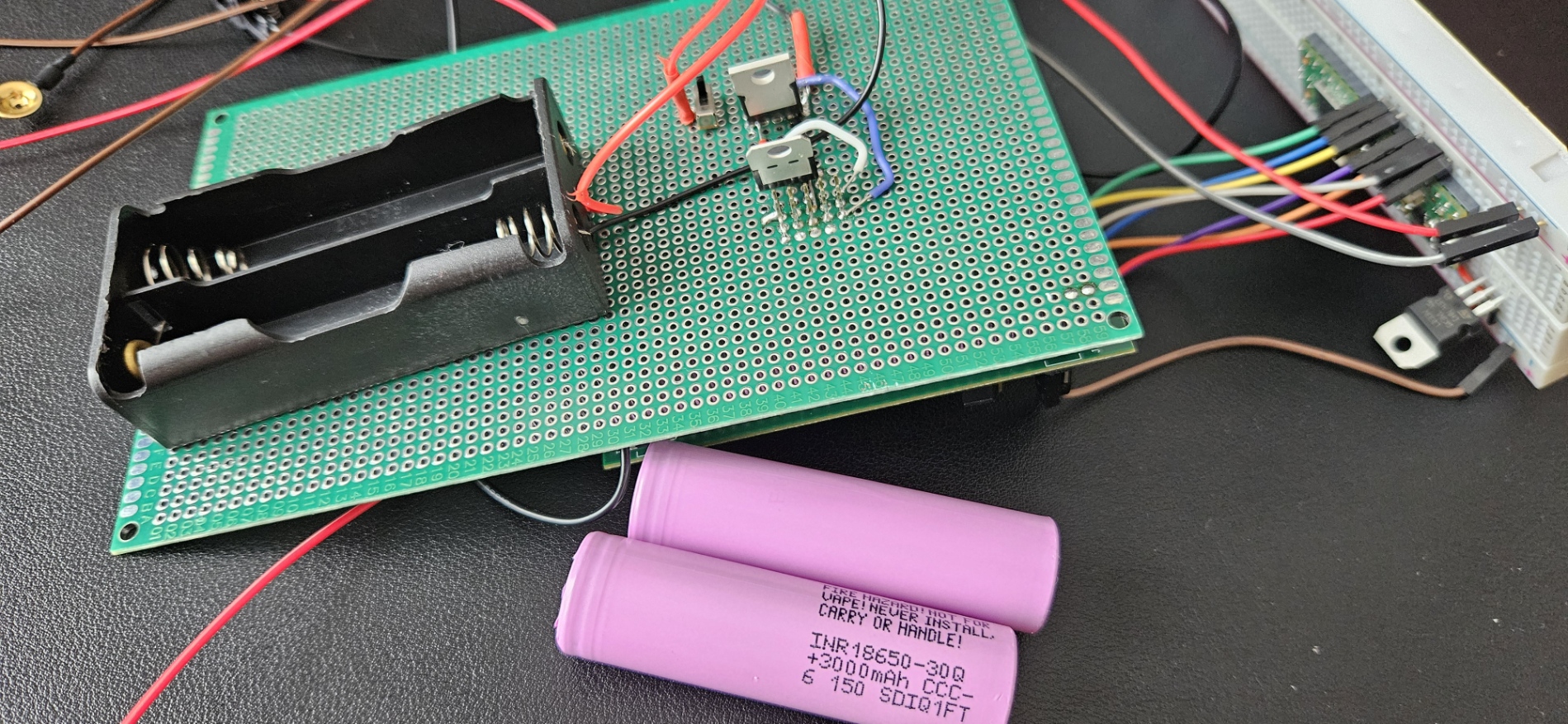 Two lithium-ion batteries and the LDO power supply soldered onto perfboard